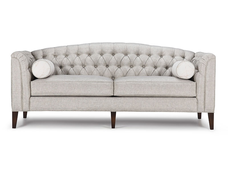 The Belmont Sofa features hand-tufted shelter arms and gently curved camelback, and long and tapered wood legs.