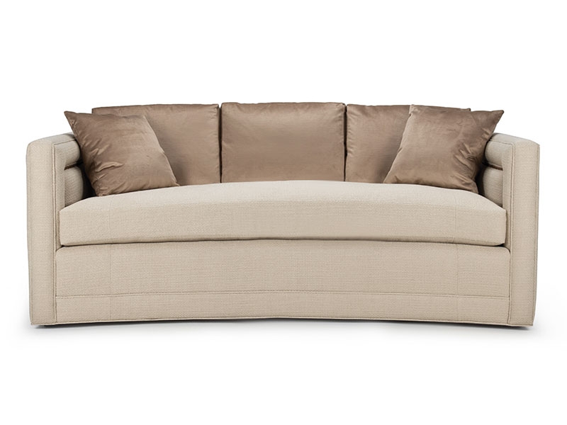 The Marilyn Sofa features a curved front and back enhanced by sophisticated, detailed piping on the arms and back, and a tailored bench cushion.